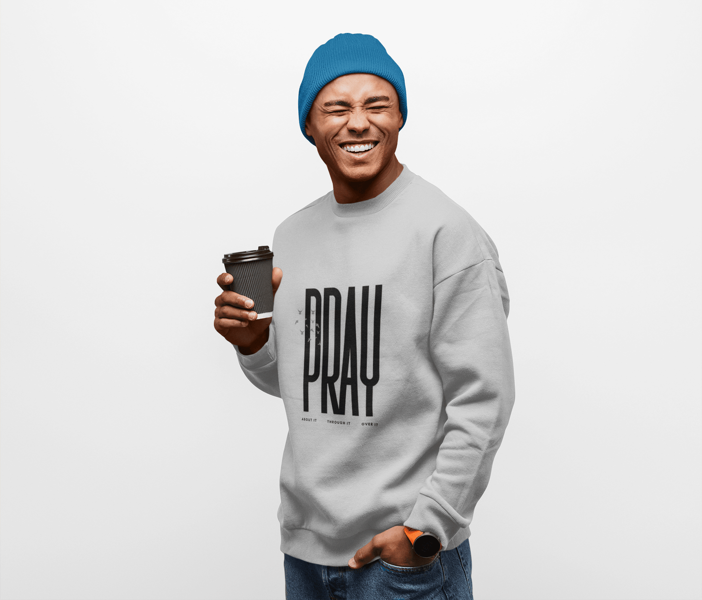 Man wearing a sport grey sweatshirt with 'PRAY' text, holding a coffee cup, on a white background