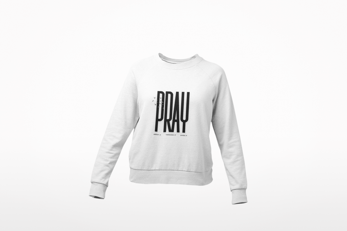 White sweatshirt with 'PRAY' printed on it against a white background