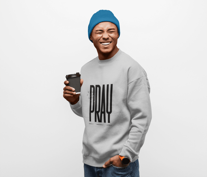 Man wearing a sport grey sweatshirt with 'PRAY' text, holding a coffee cup, on a white background