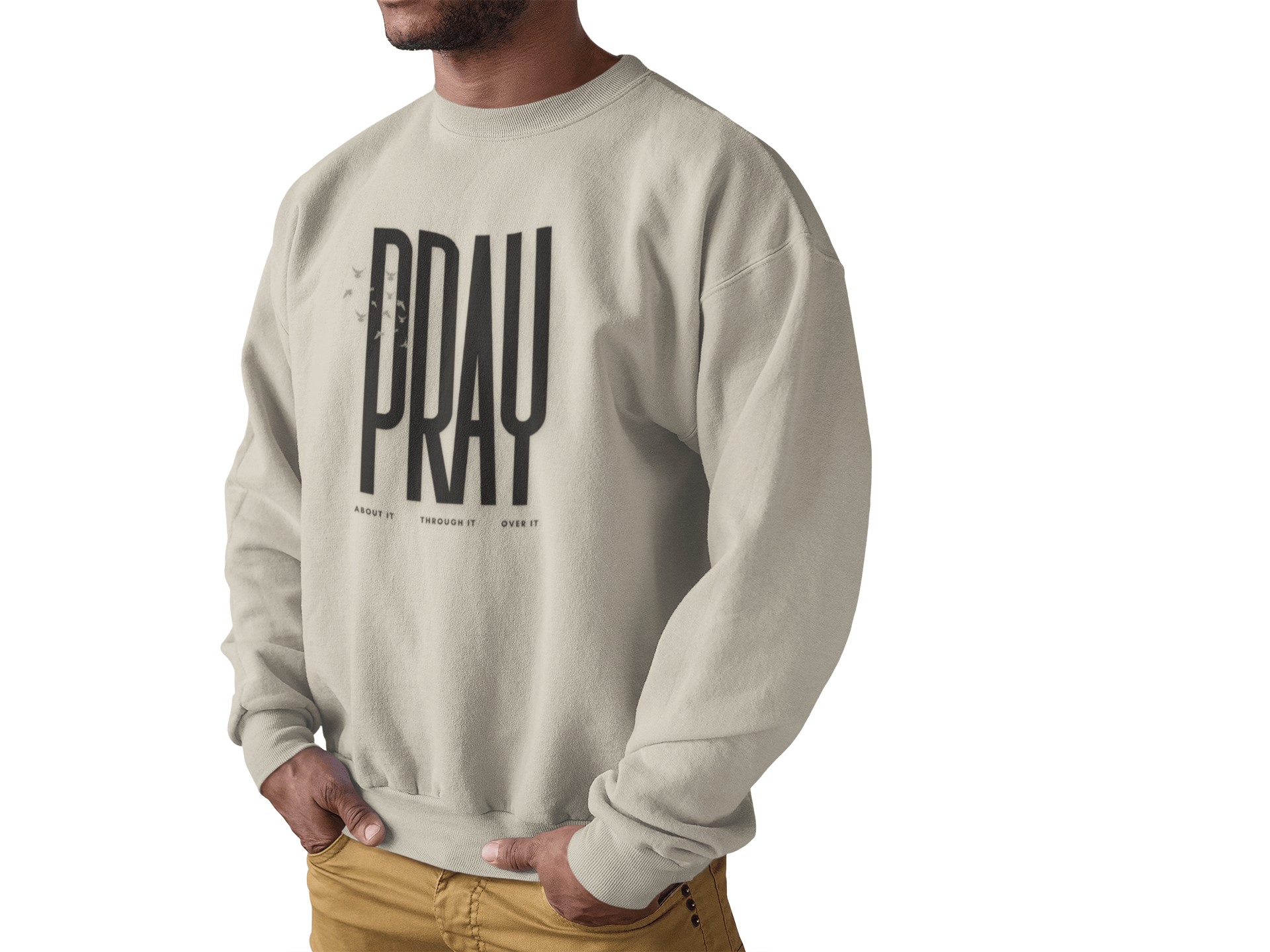 Sand sweatshirt with 'PRAY' printed on it worn by a man on a white background