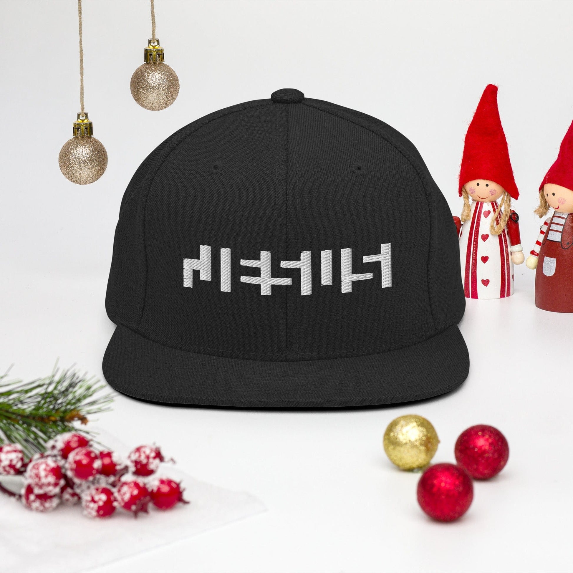 Black snapback with "Jesus" in white embroidery with background of christmas Decor