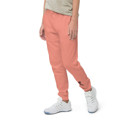 left view of woman wearing dusty rose Joggers with black Konsecrate Signature logo on left leg